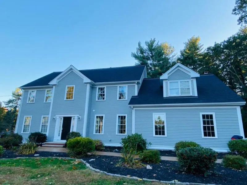 Pale blue clapboard colonial in MetroWest Boston after a full exterior repaint by Target Painting