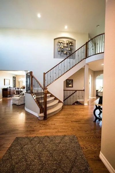Two-storey foyer with a curved staircase and repainted trim