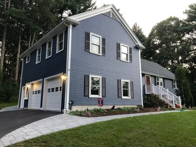 Blue-gray colonial exterior with crisp white trim after painting by Target Painting