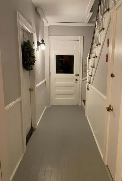 Hallway repainted in a clean white with new trim