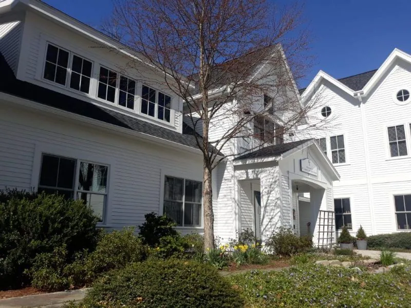 White farmhouse and ell after a complete exterior repaint