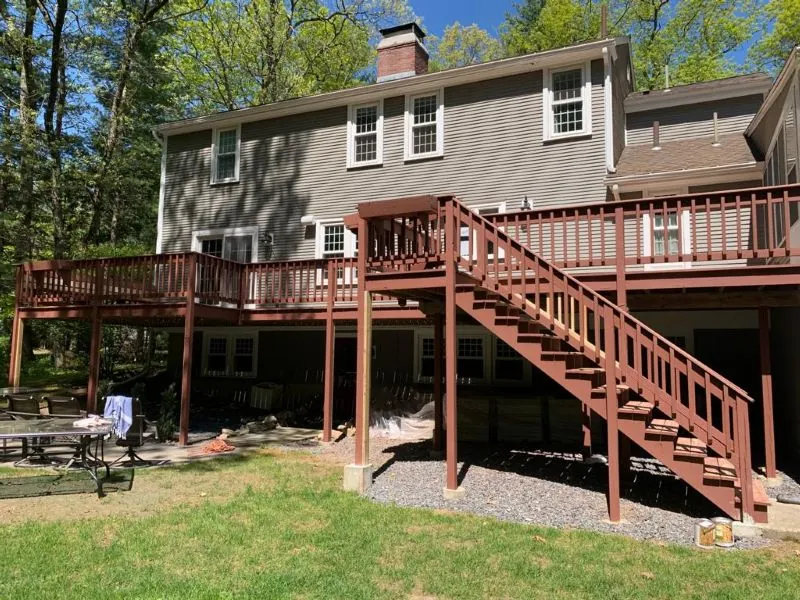 Large raised deck and stairs finished in a red-brown stain