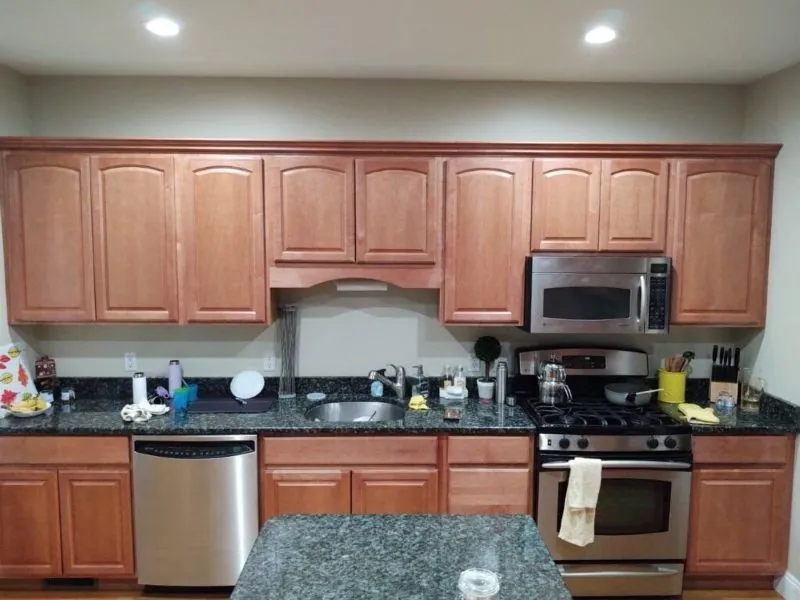 Oak kitchen cabinets refinished in a soft cream — before