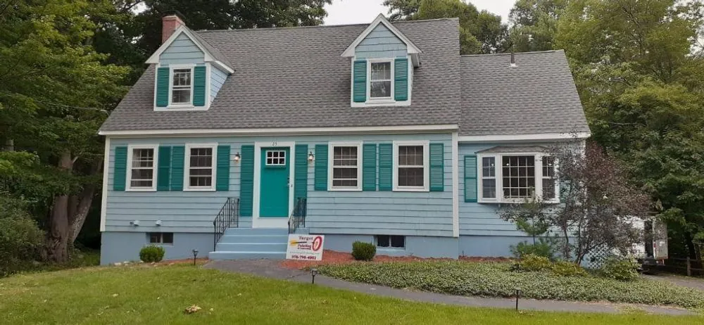 Grey cape with teal shutters, dormers and repainted trim
